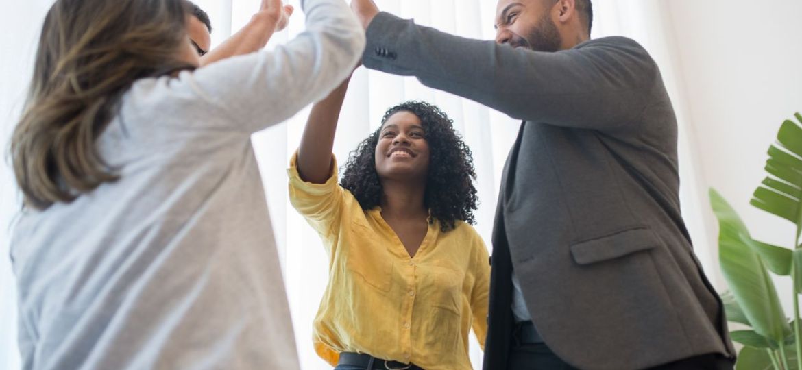 Group high five, team celebrating success